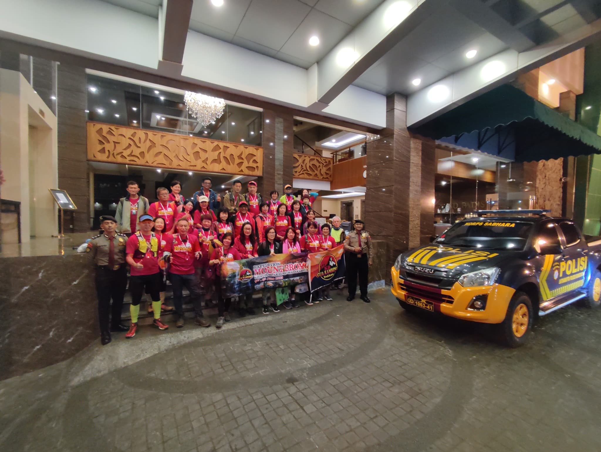 Police support vehicle with group prior to tour departure